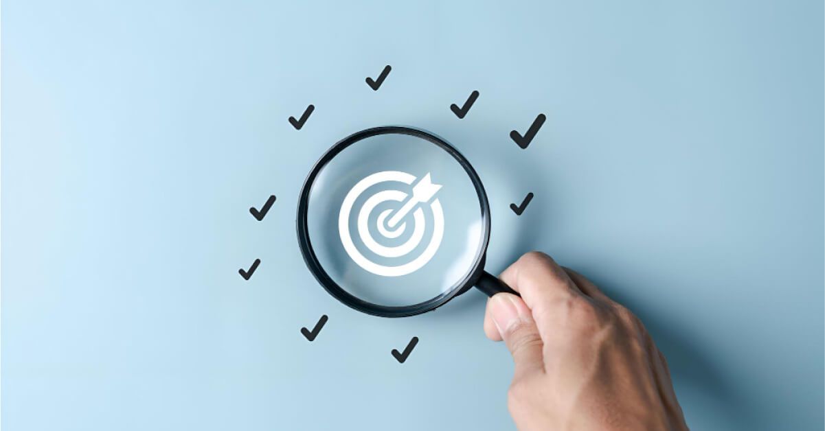 A magnifying glass hovering over a vector dart board, with checkmarks around it