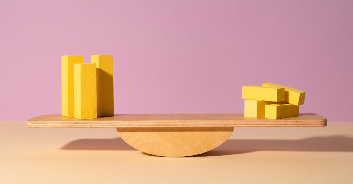 A seesaw balancing yellow blocks on both sides.