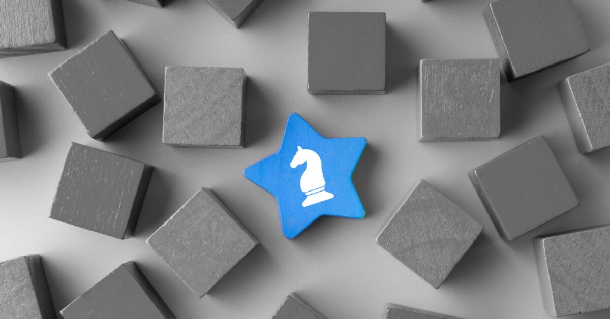 A star shaped blue block with a chess knight graphic placed amongst grey blocks