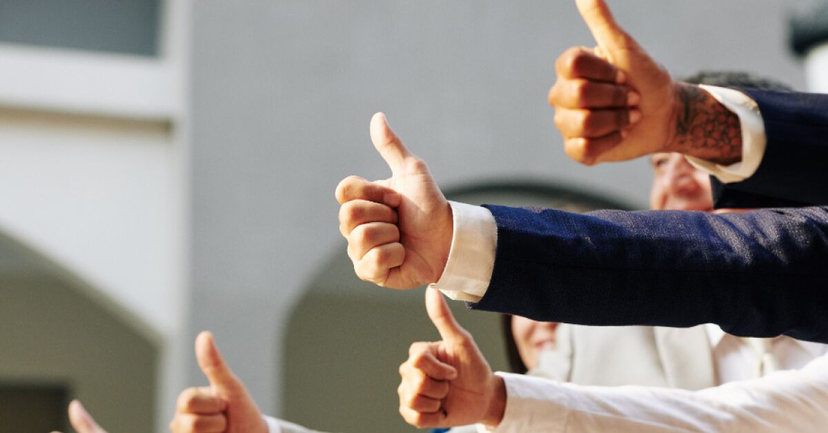 Group of people giving the thumbs up