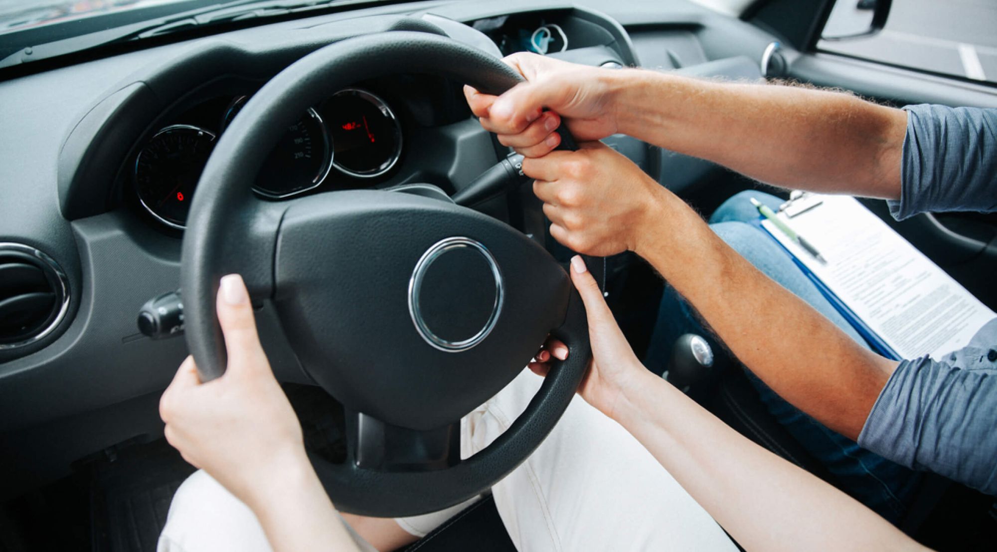 A group of people holding driving wheel