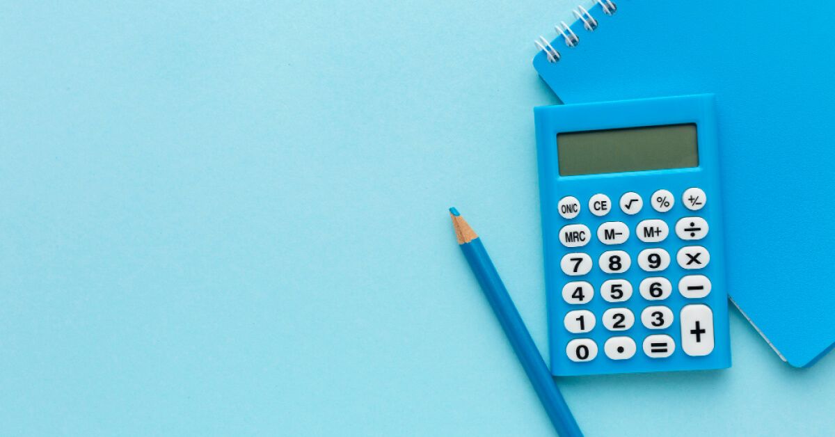 A blue pencil, calculator and notebook