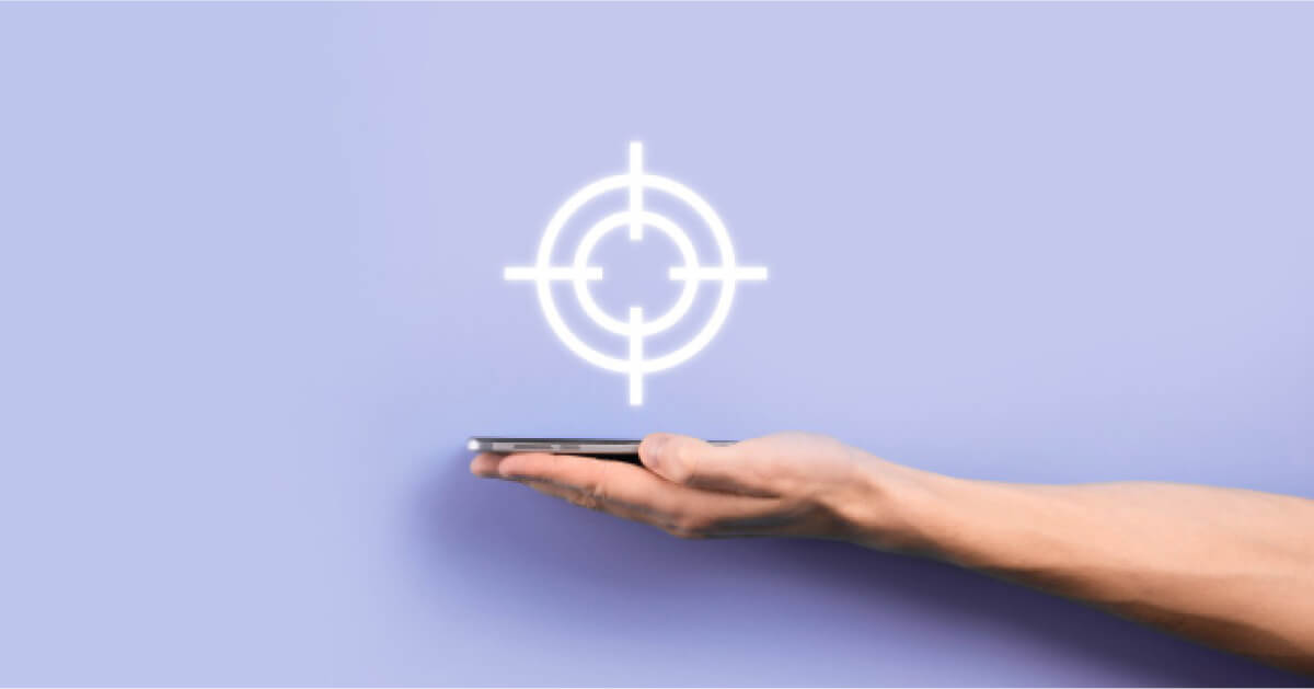 Person holding a phone with a target graphic hovering over the screen