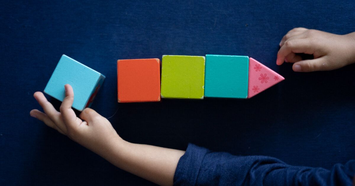 Colourful wooden blocks stacked in a straight line