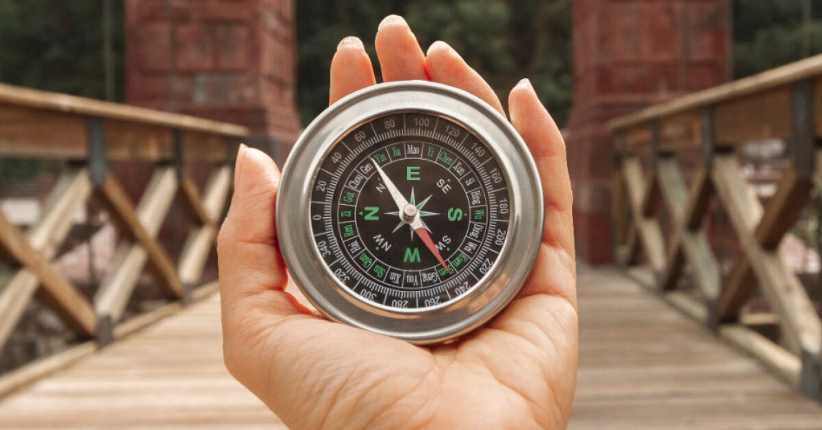 A woman holding a compass