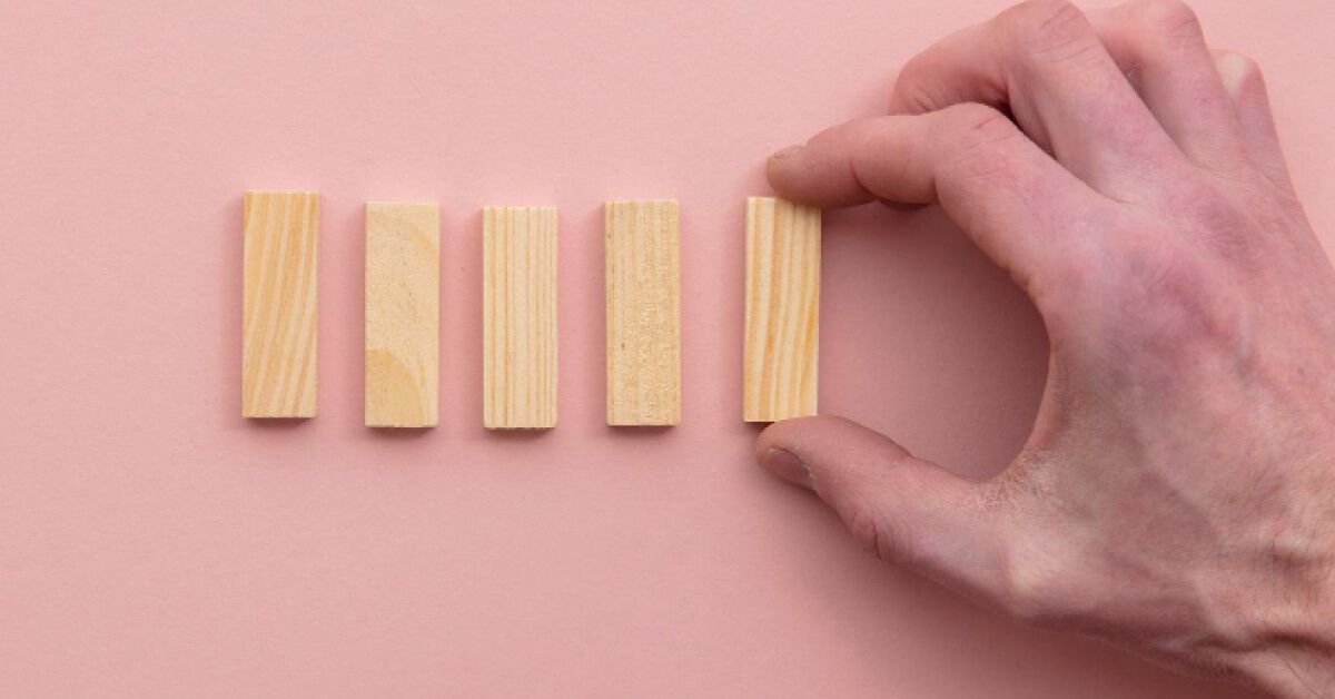 A man arranging four blocks 