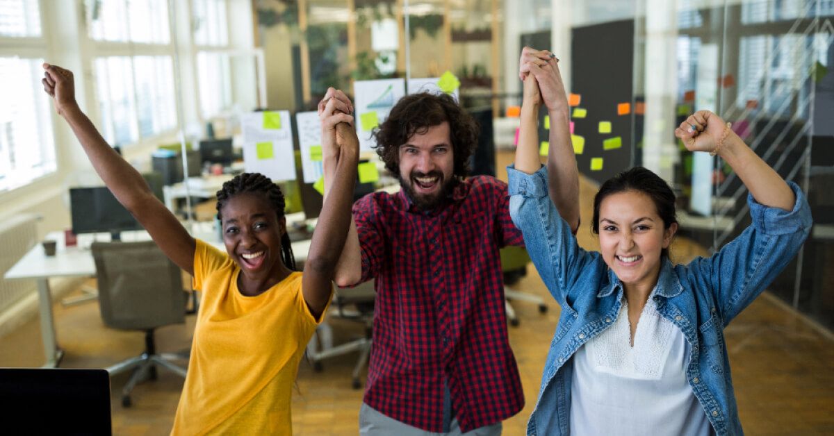 Employees cheering with hands held up