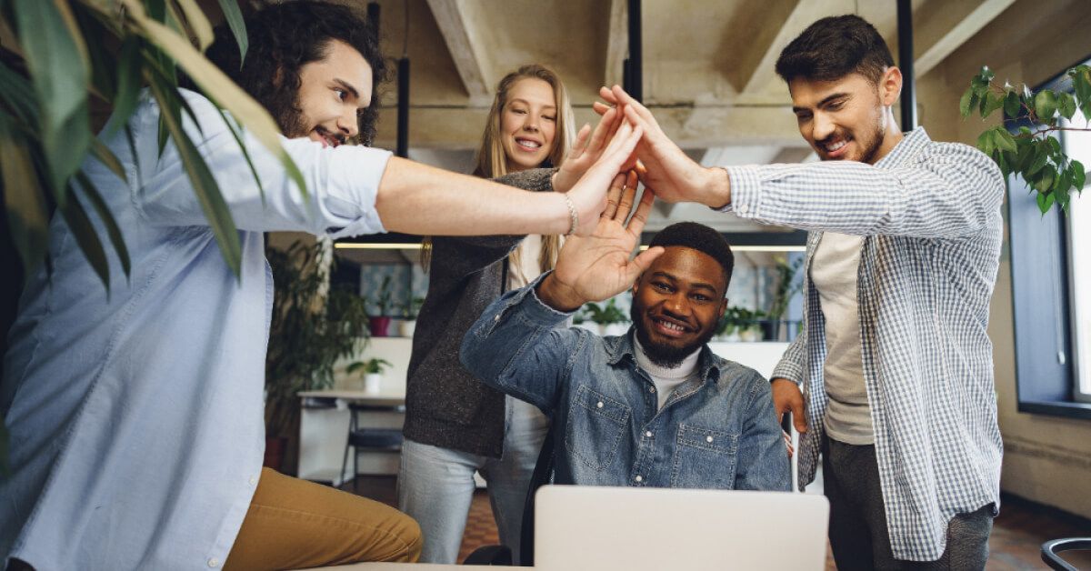 A team of people participating in a group high five