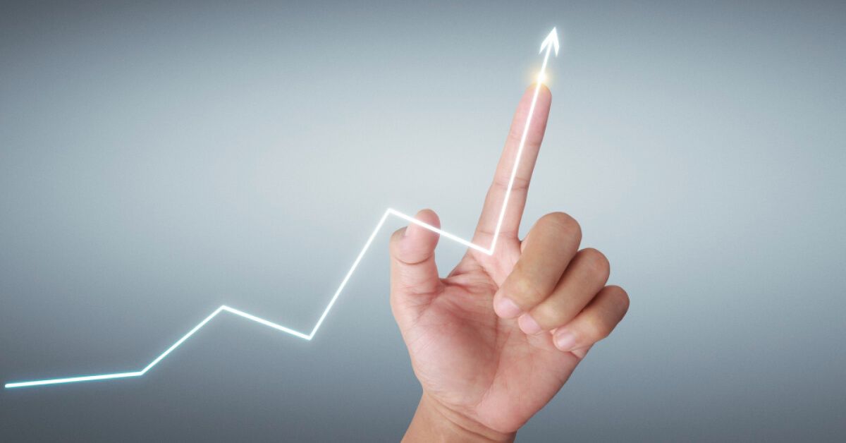 Person pointing at an upward moving glowing arrow