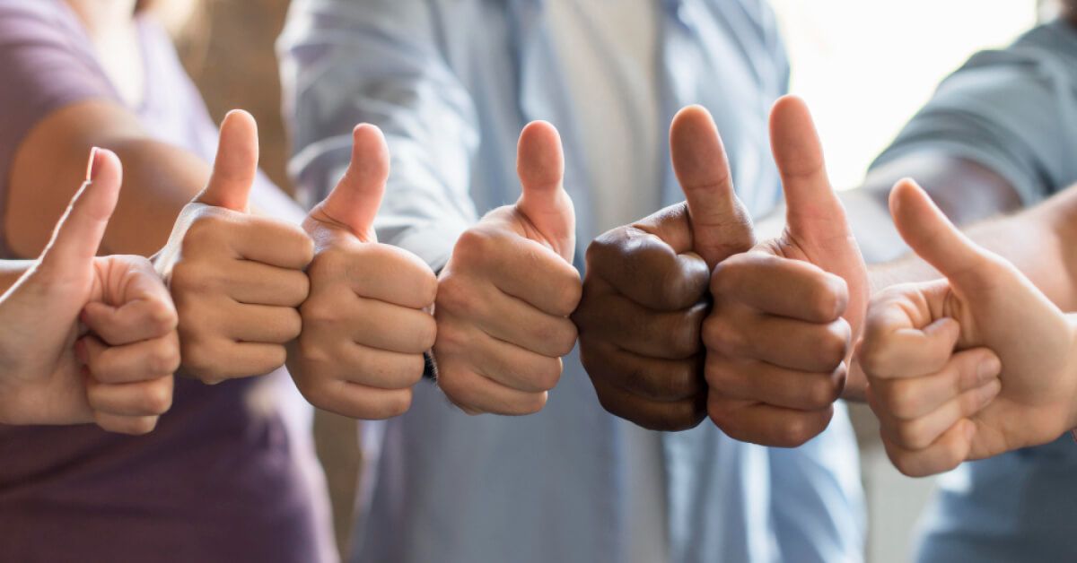 Varied group of people with thumbs ups