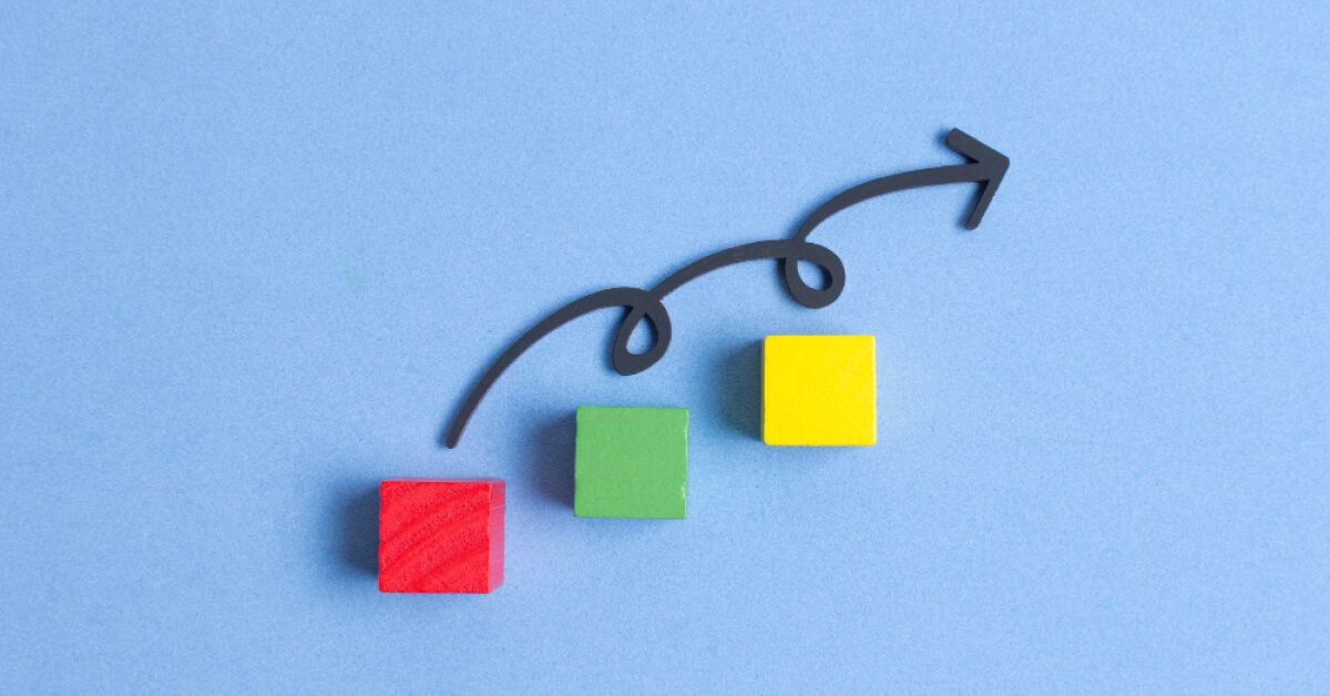 Three wooden blocks with arrow mark in blue background