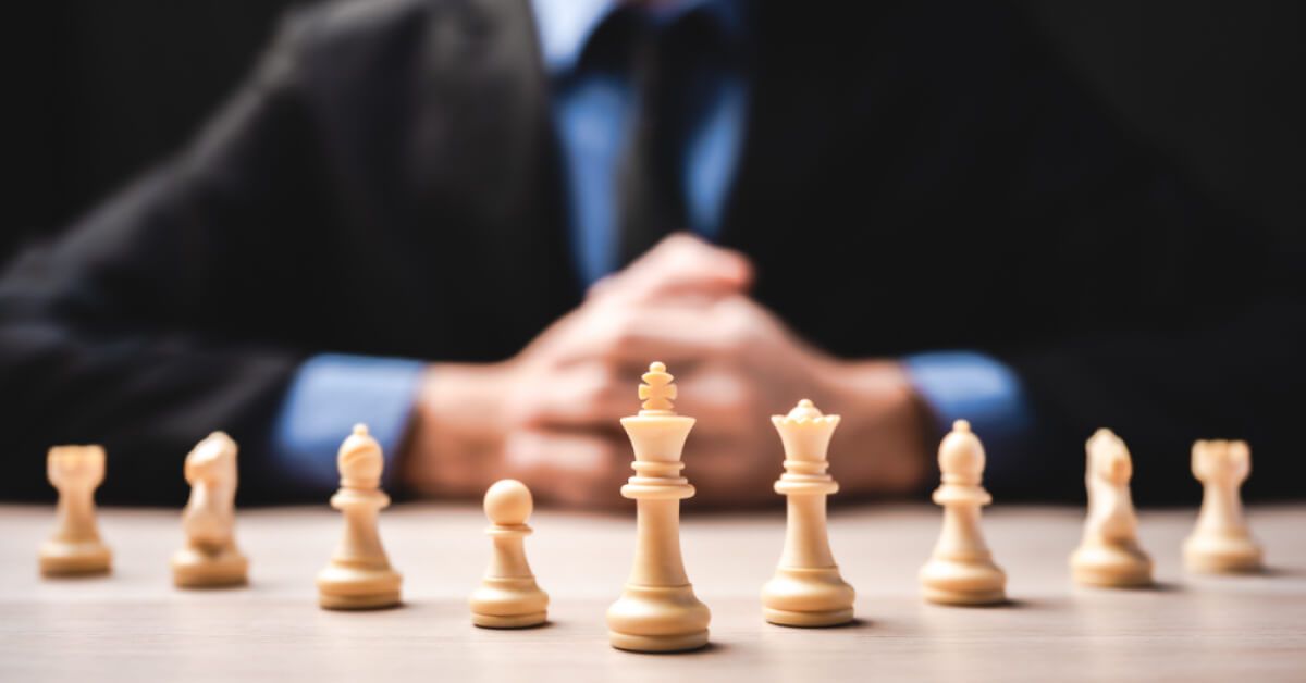 A chess set and man sitting behind