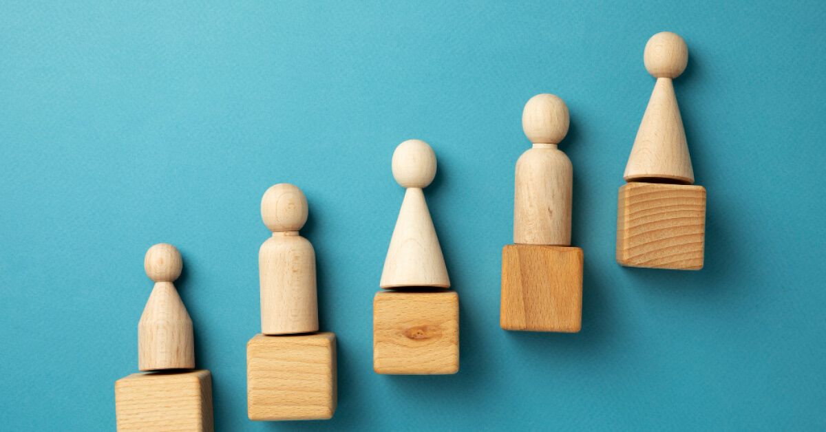 Wooden pawns on top of wooden blocks