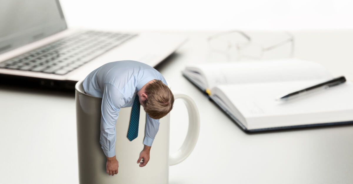 Miniature frustrated HR professional in a coffee mug