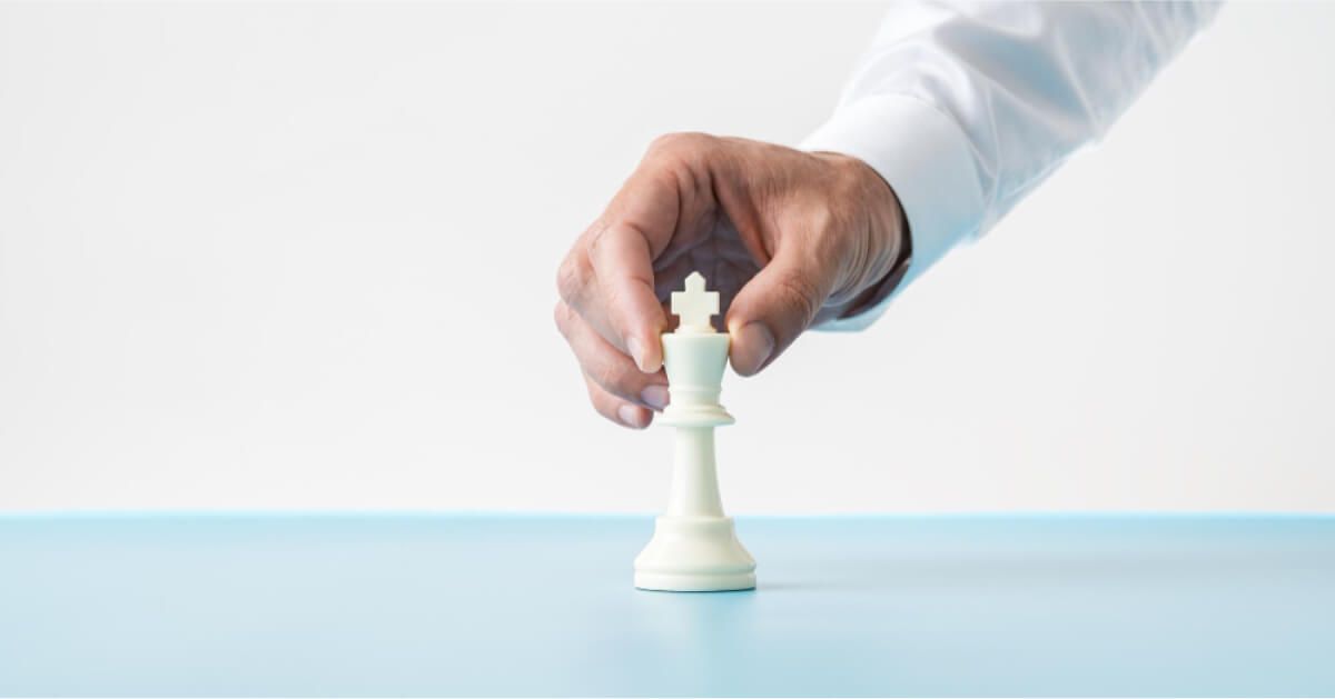 A hand placing chess figure