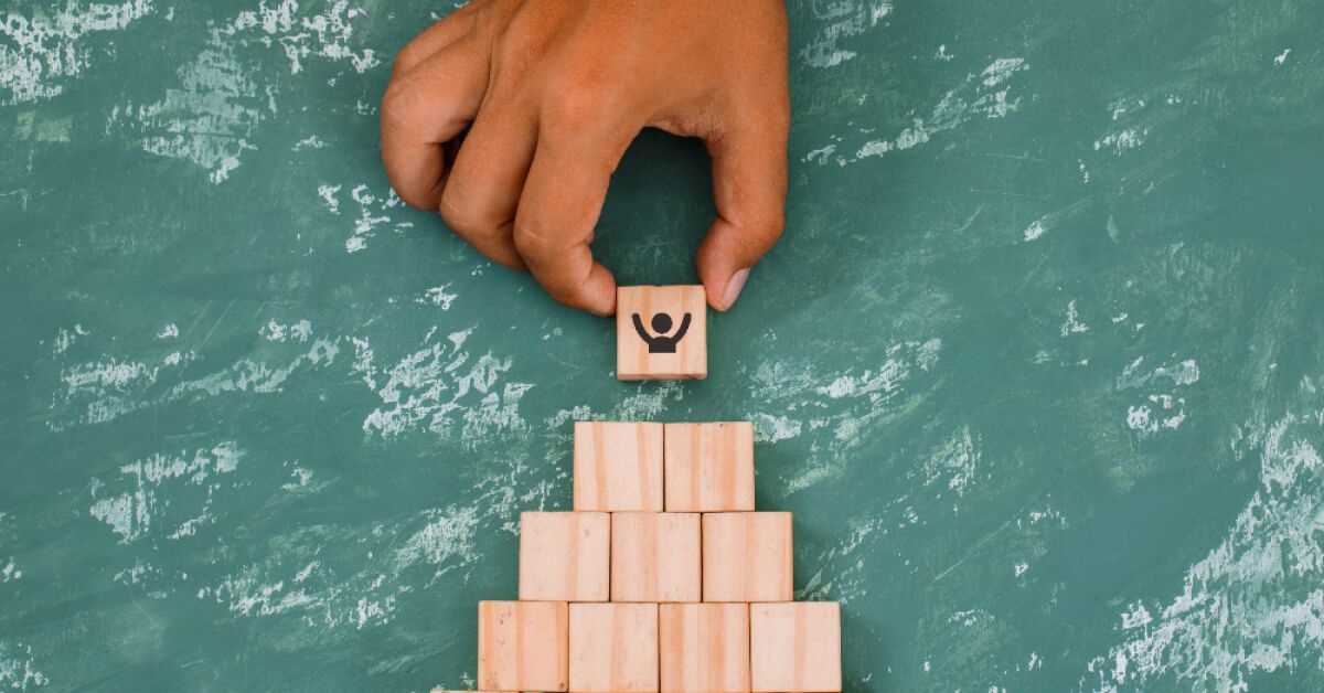 A man arranging wooden blocks