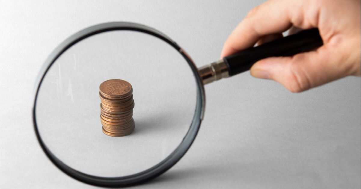 A stack of coins under a magnifying glass