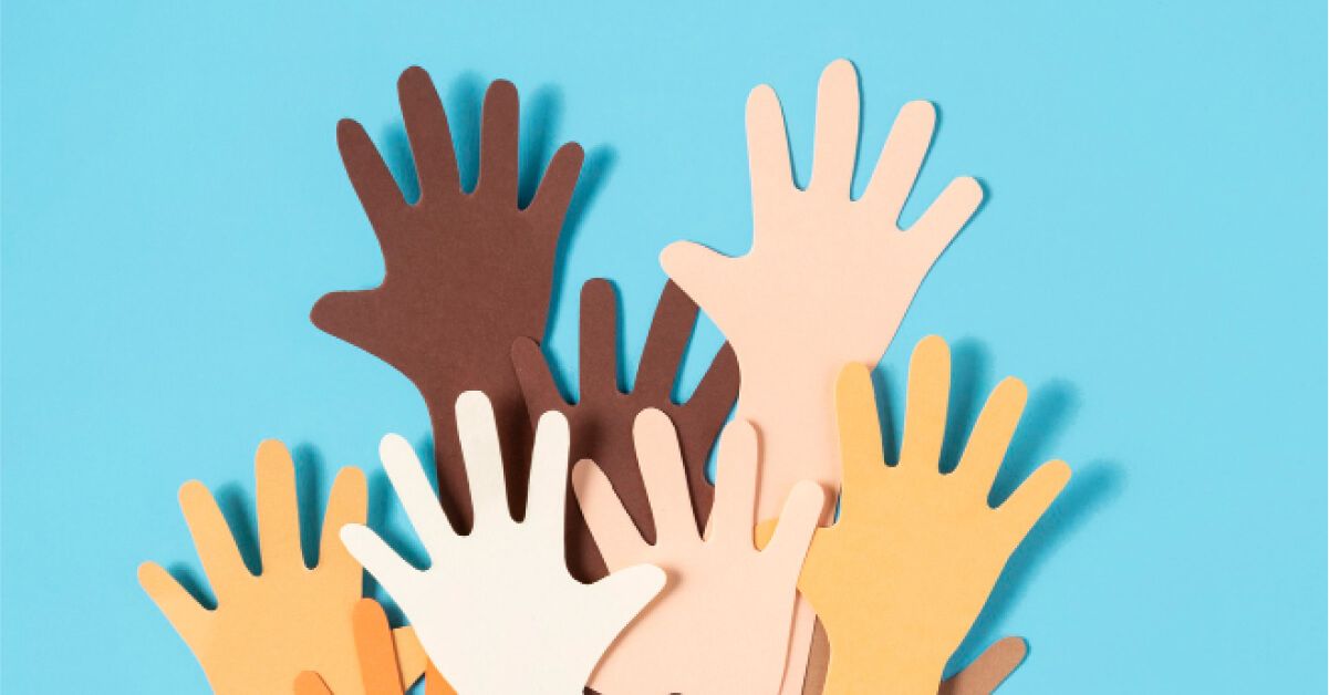 Paper cutouts of a diverse group of raised hands