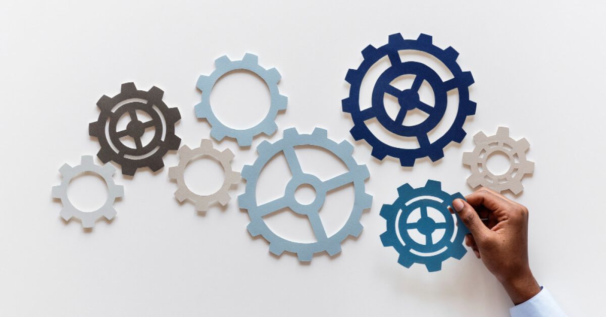 Multicolored paper cutouts of varying gears