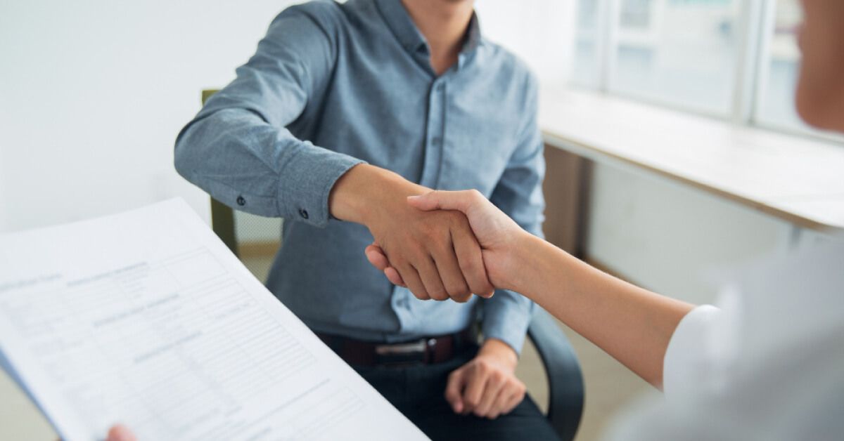 Two people shaking hands with an agreement