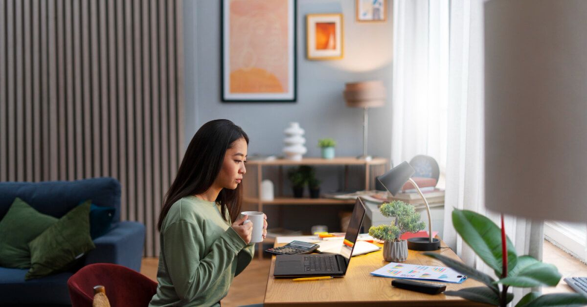 Person in front of a laptop in a remote work environment