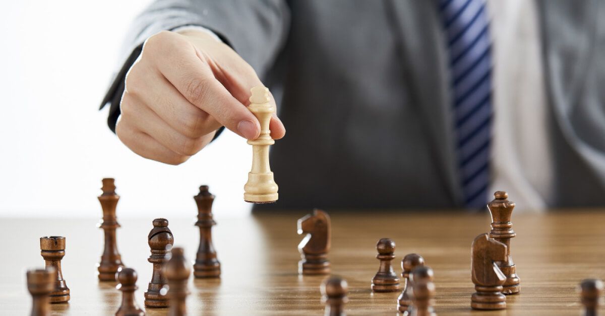 Person moving a white chess piece