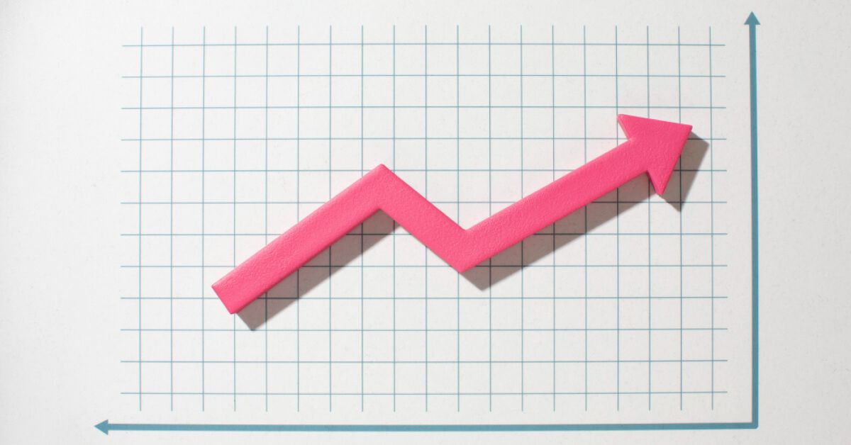 An upward moving pink arrow against a graph