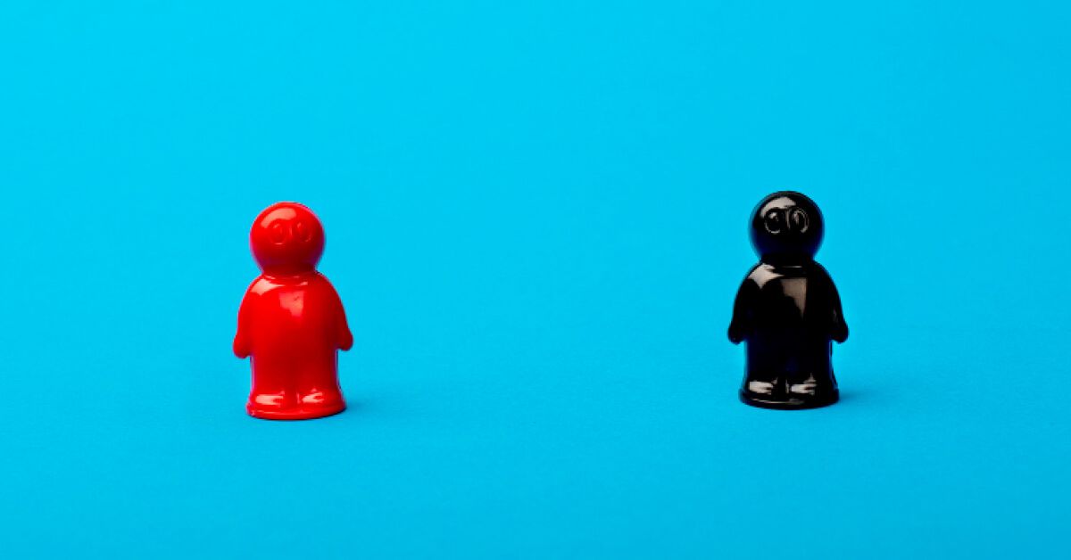 Red and black figurines against a blue backdrop