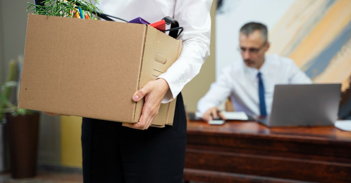 Employee leaving with a packed cardboard box