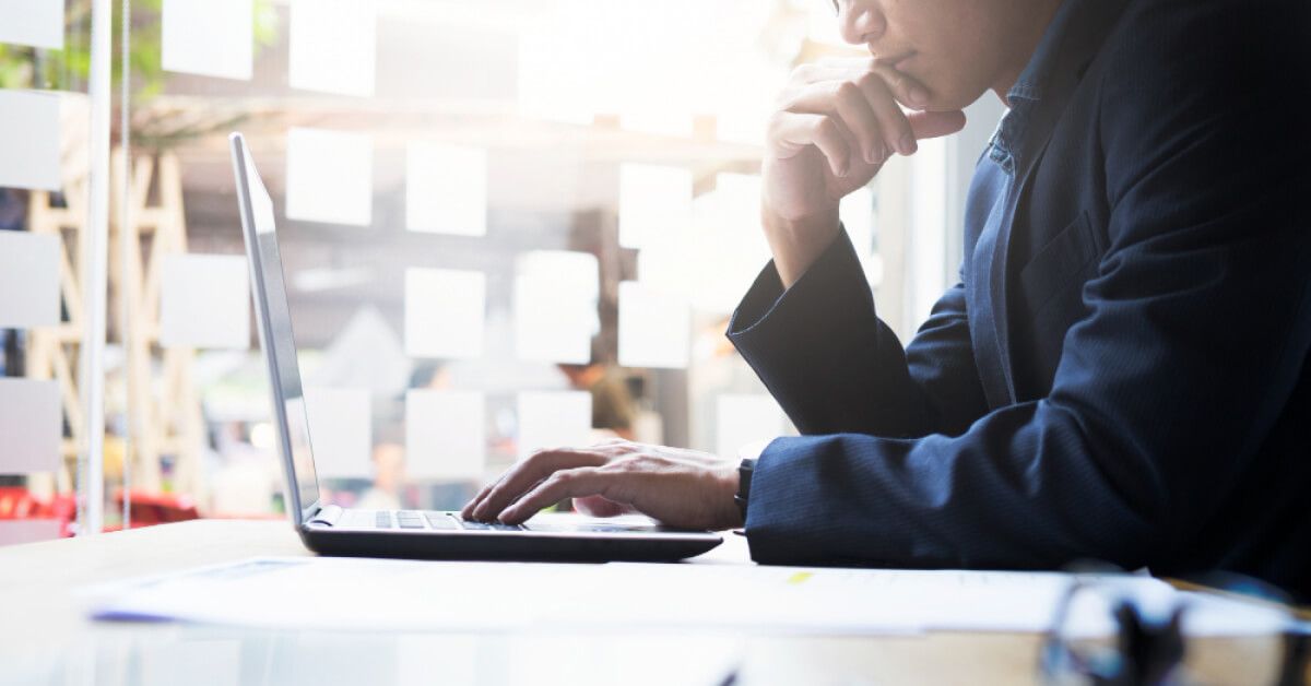 Person using a laptop in an office environment