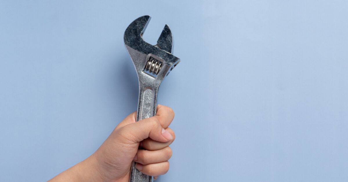 Person holding a wrench