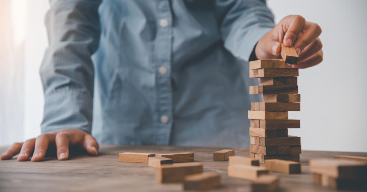 A male stacking jenga blocks