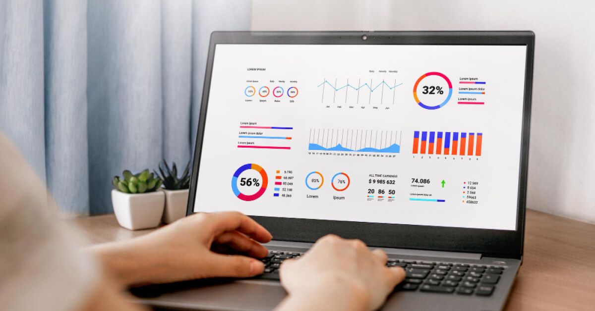 Person using a laptop with lots of statistics on the screen