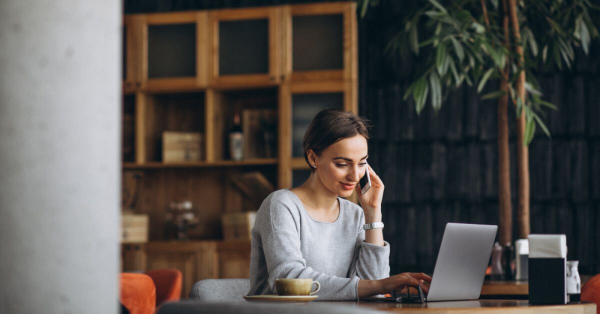 Woman on the phone while working on a laptop