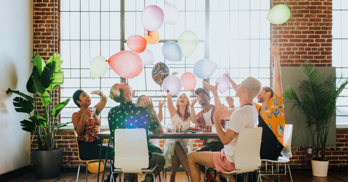 Employees are celebrating in their workplace with balloons 