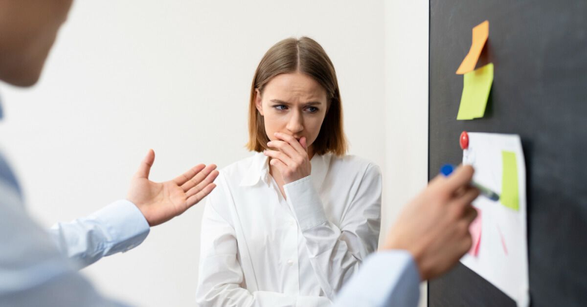 Person explaining something in front a bulletin board