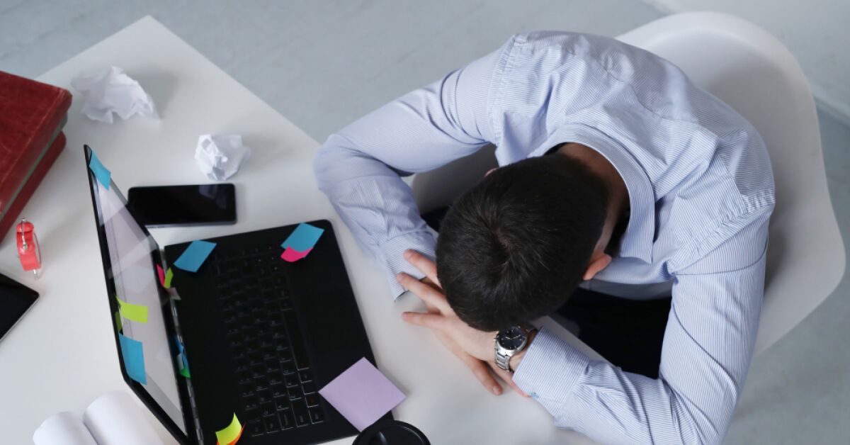 Frustrated employee in front of a laptop screen