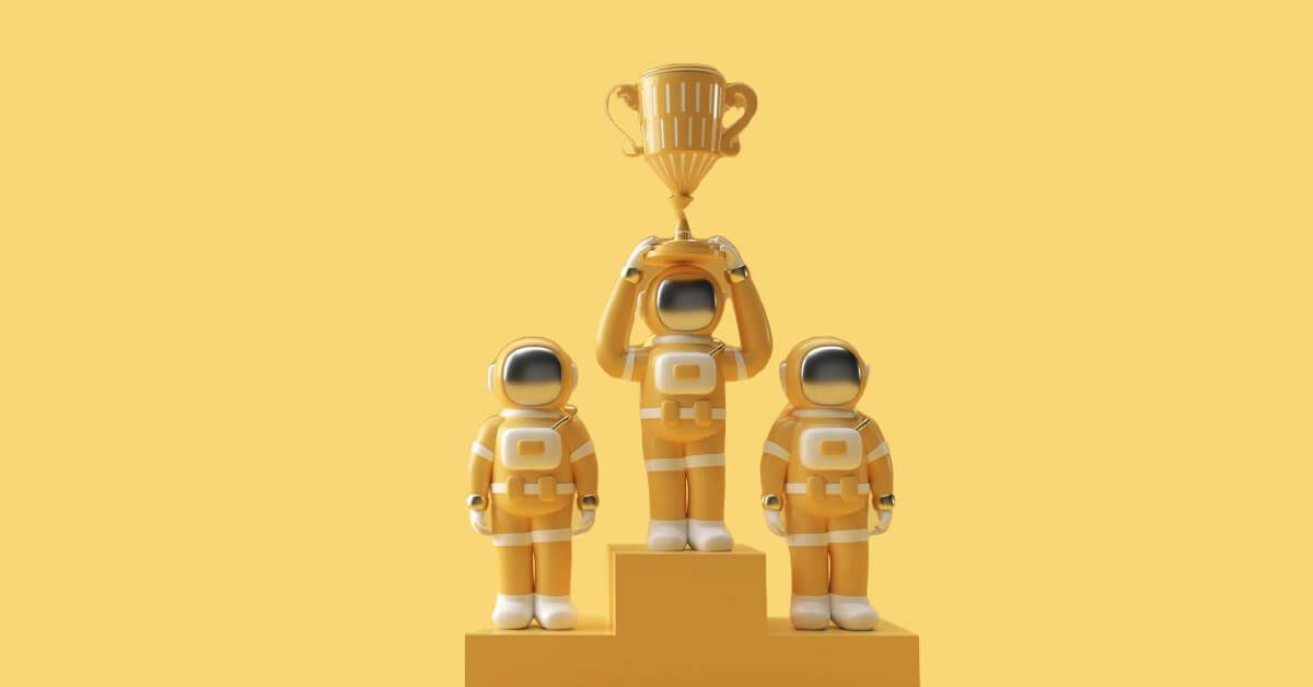 Miniature toys on a podium with a trophy