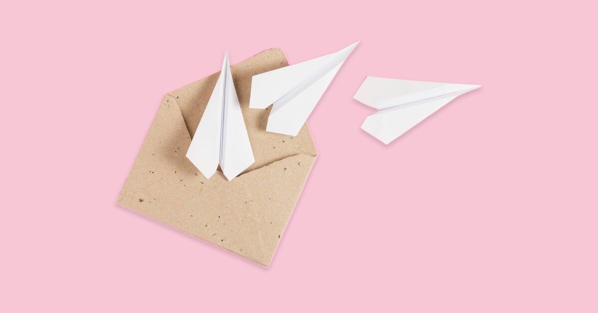 Paper planes next to an open envelope