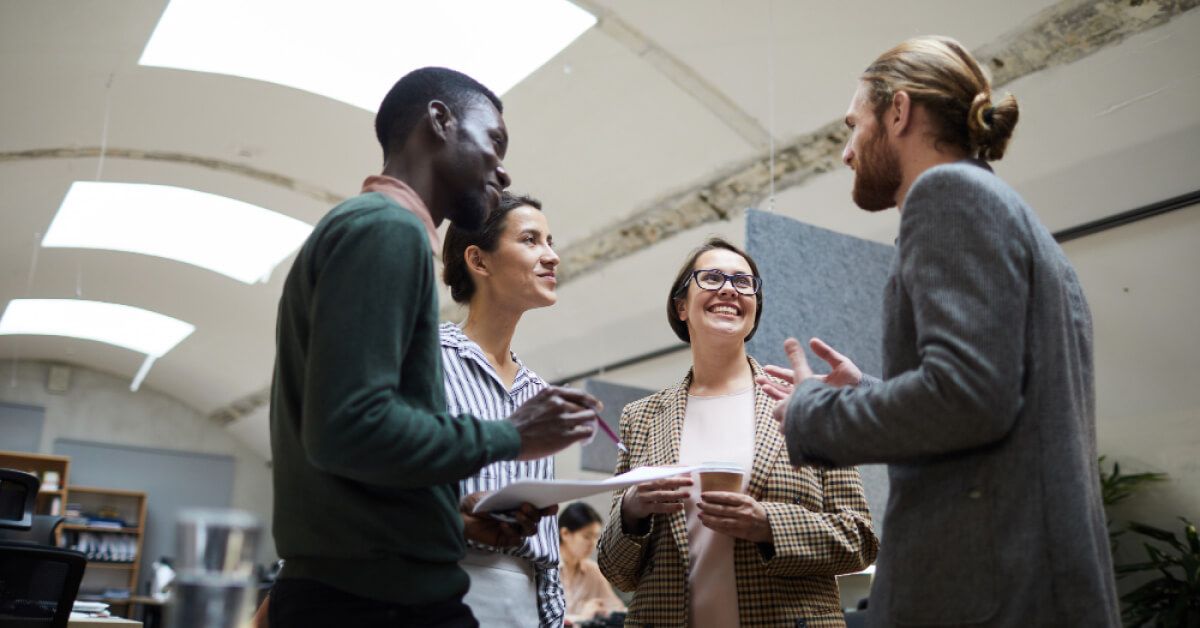 A group of employees talking to each other