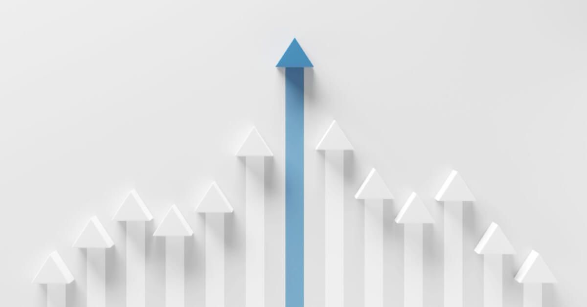 A blue upward moving arrow amongst smaller white arrows