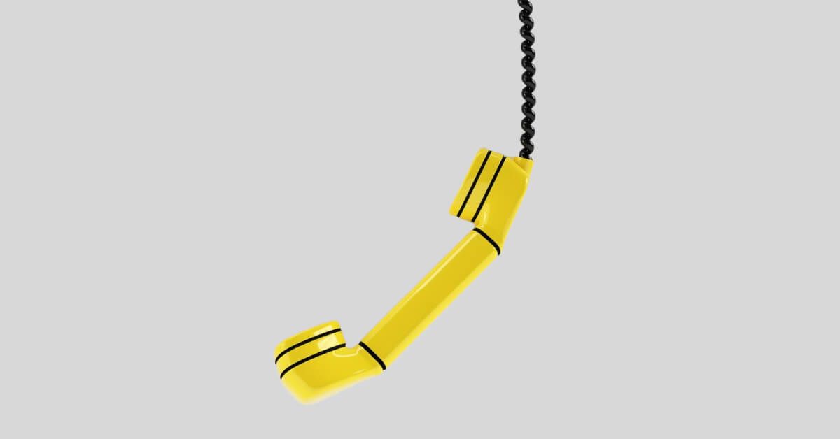 Yellow telephone receiver that's suspended