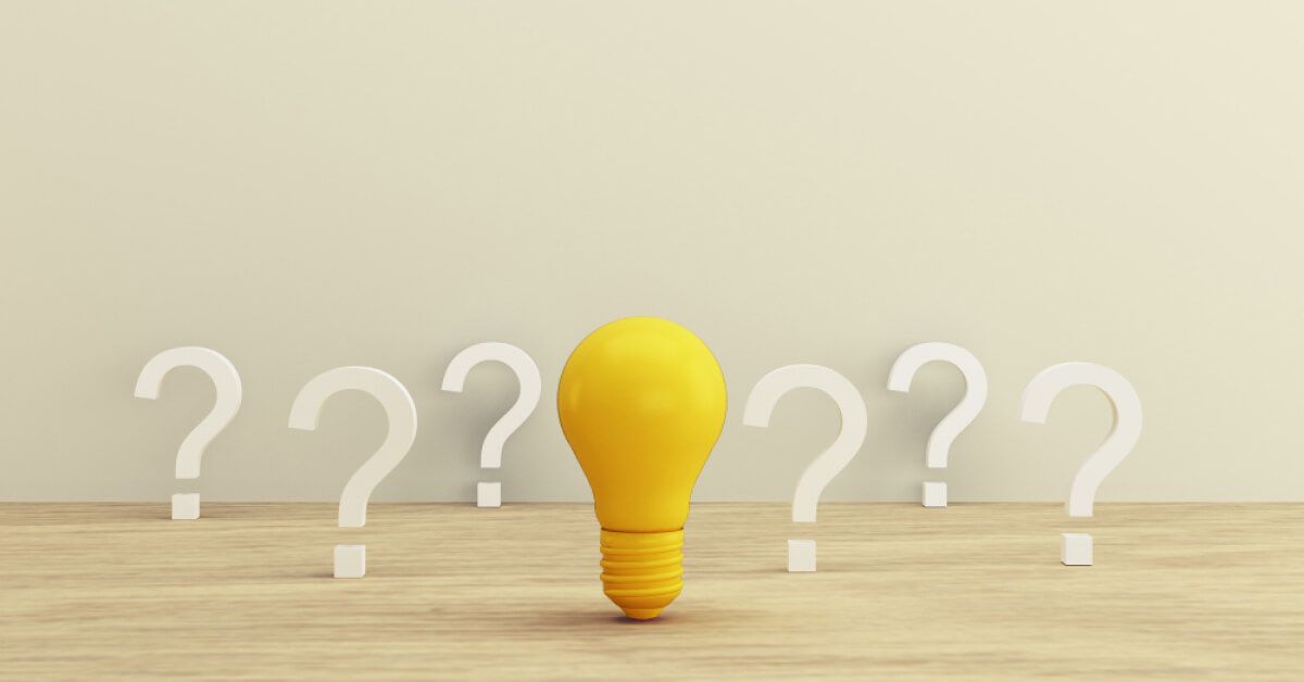 Yellow bulb surrounded by question marks