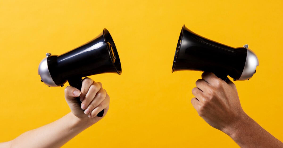 Two mini megaphones pointing at each other