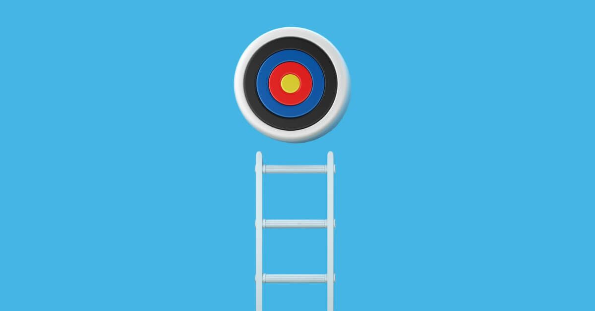 Ladder leading up to a target board against a blue backdrop