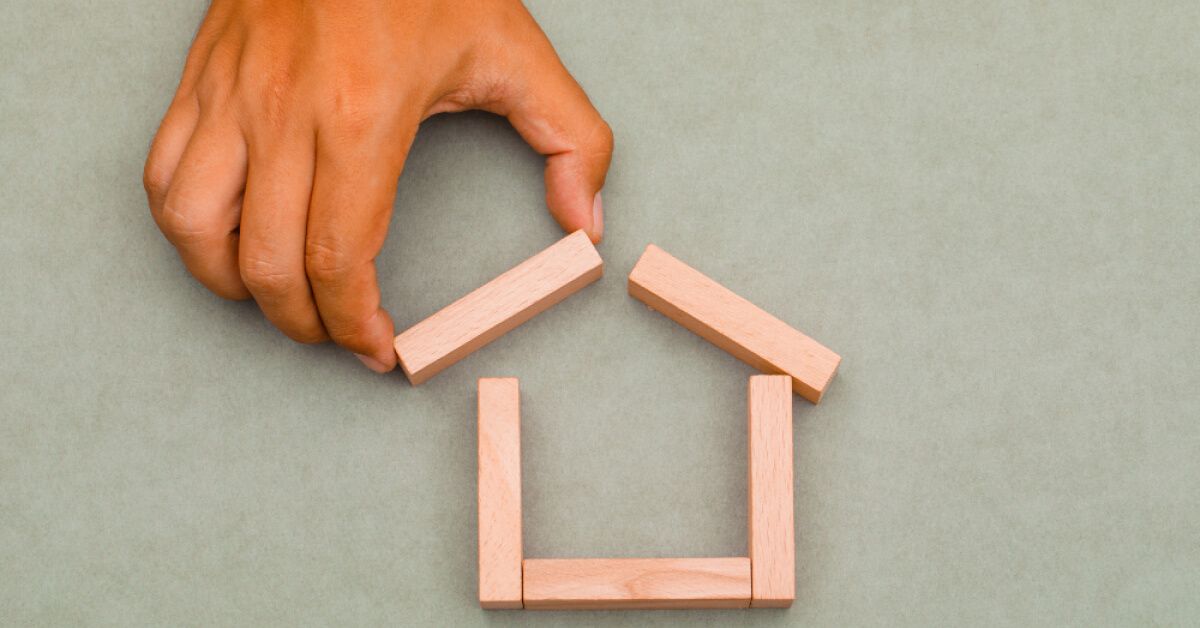 A hand making wooden house