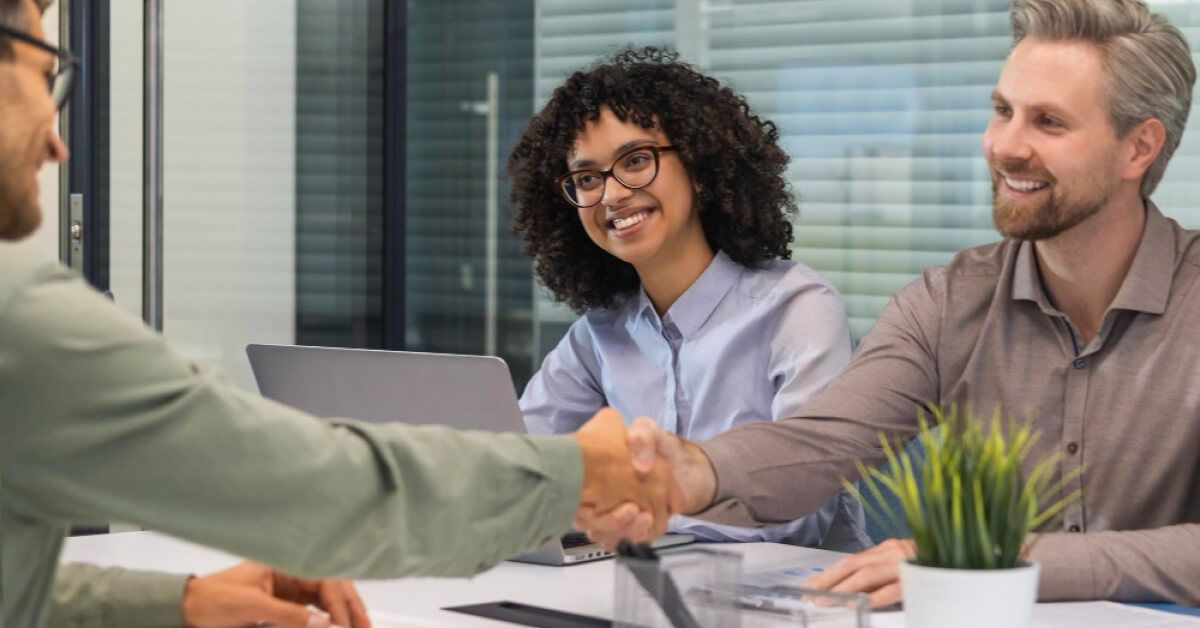 A handshake between two people in a meeting