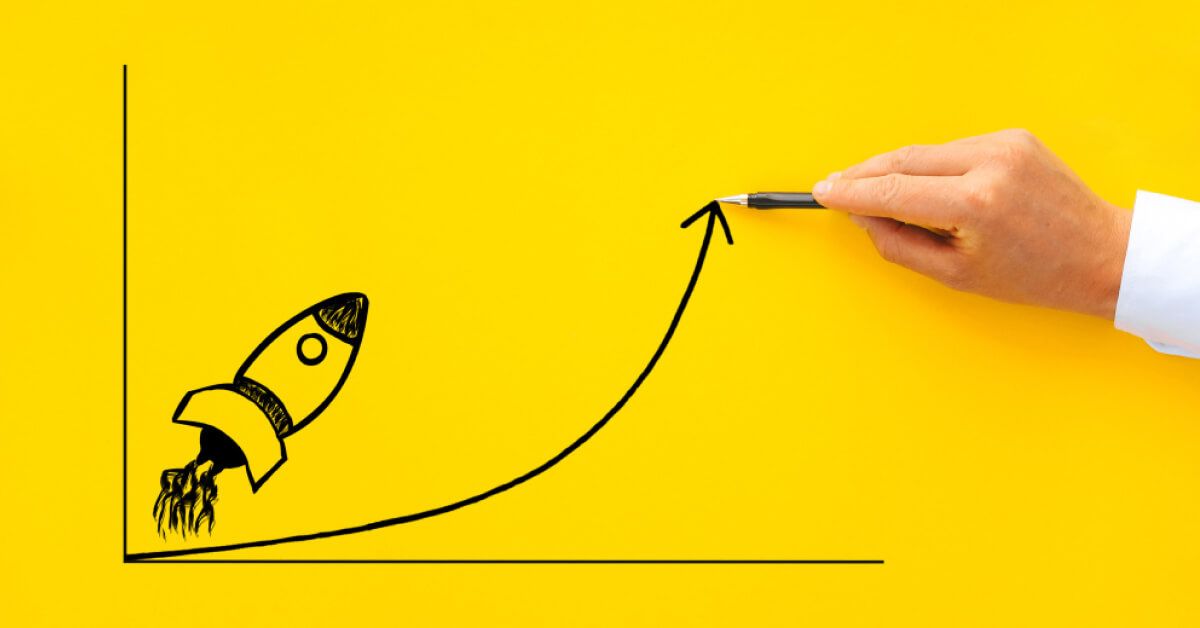 Person pointing at an upward arrow in a graph with a rocket visual