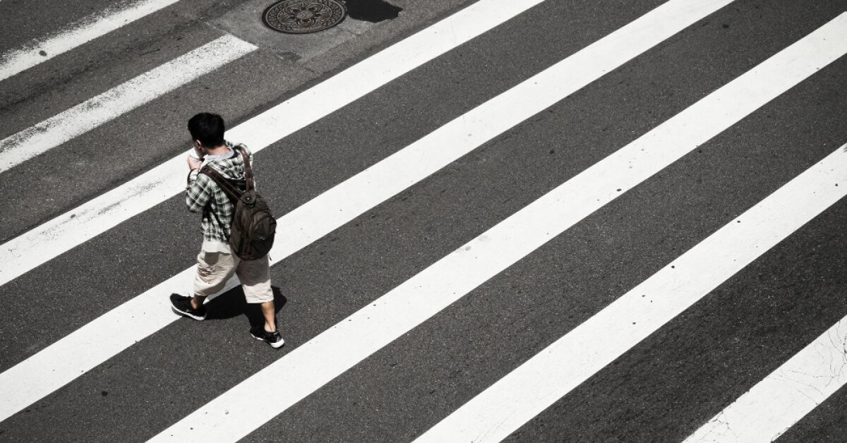 Person walking across a zebra crossing