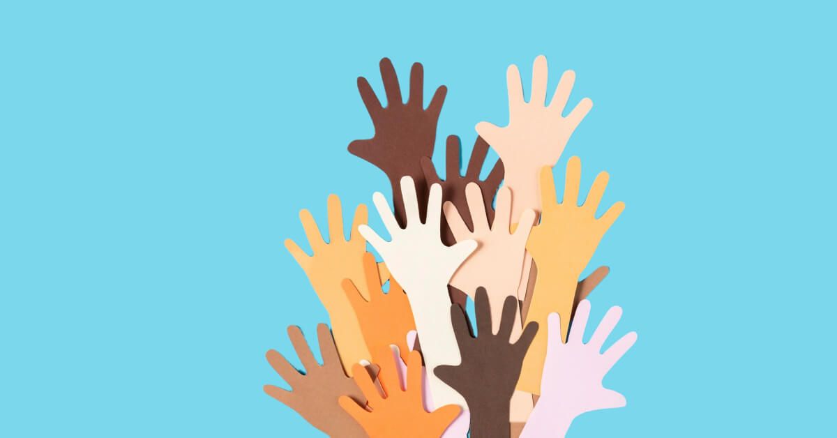 Paper cutouts of a diverse group of raised hands